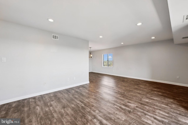 unfurnished room with dark hardwood / wood-style flooring