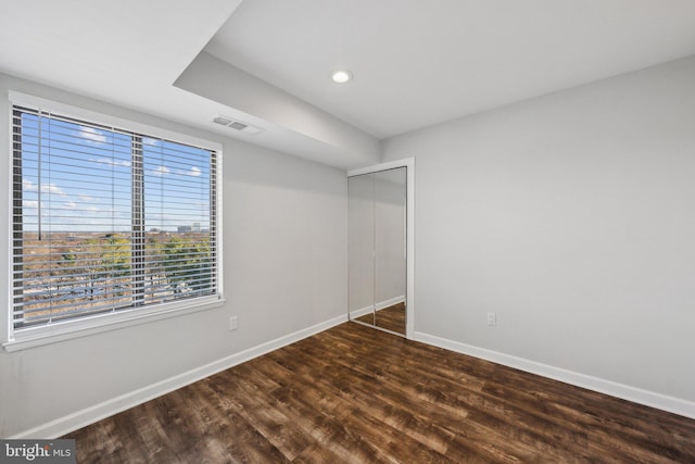 spare room with dark wood-type flooring