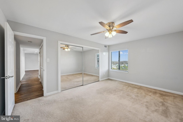 unfurnished bedroom featuring ceiling fan, a closet, and carpet floors