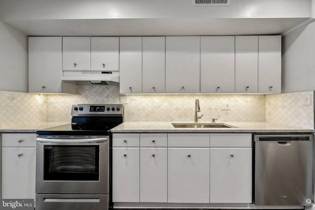 kitchen featuring stainless steel appliances, sink, and backsplash