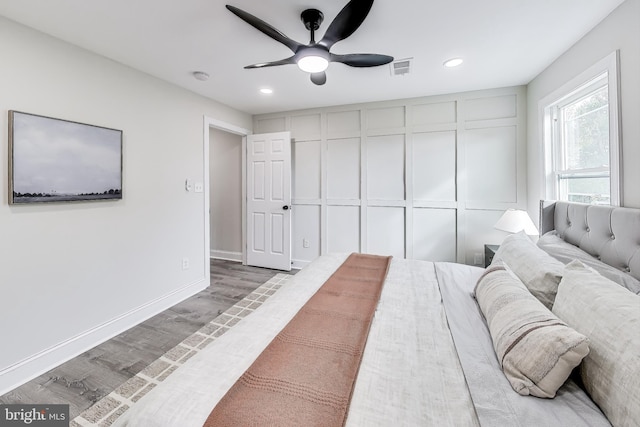 bedroom with a closet, ceiling fan, and hardwood / wood-style floors