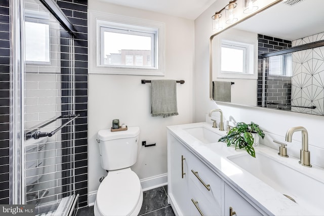 bathroom with tile patterned flooring, vanity, and a wealth of natural light