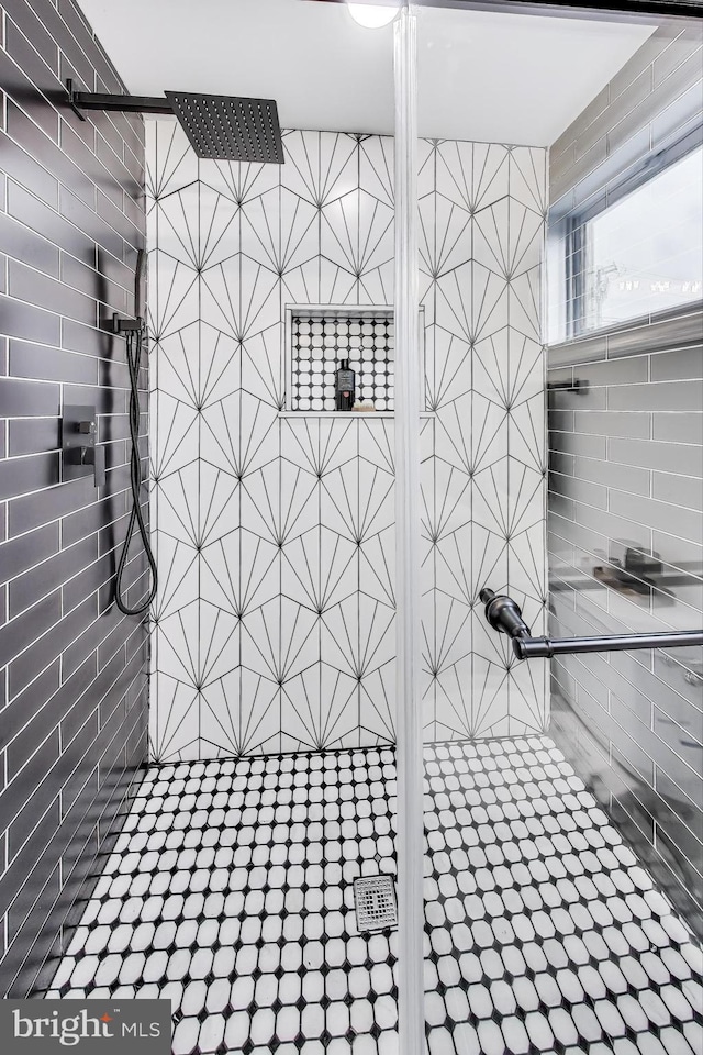 bathroom with a tile shower