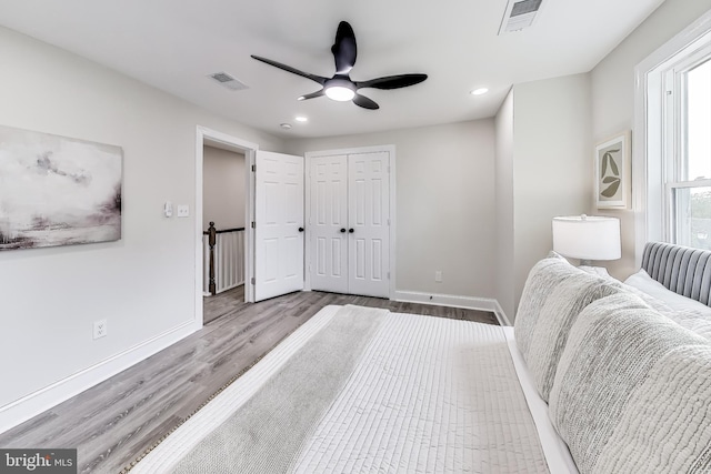 bedroom featuring a closet, ceiling fan, and light hardwood / wood-style flooring