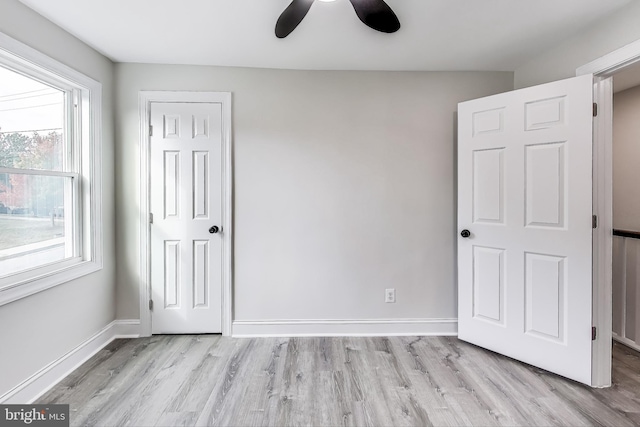 unfurnished bedroom featuring ceiling fan and light hardwood / wood-style floors