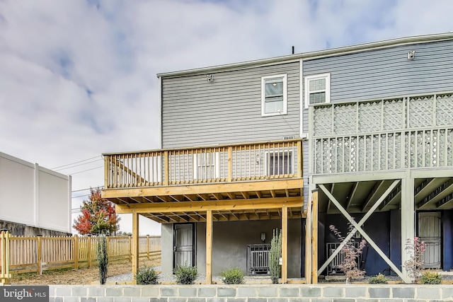 back of property with a wooden deck