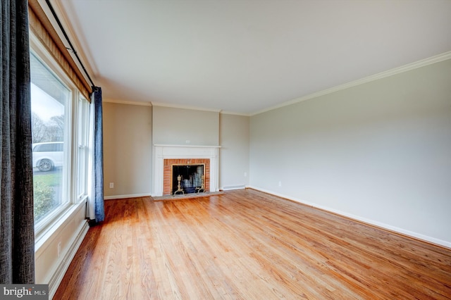 unfurnished living room featuring a fireplace, light hardwood / wood-style flooring, and crown molding