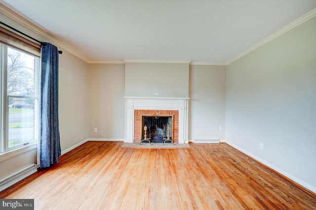 unfurnished living room with a fireplace, hardwood / wood-style flooring, and ornamental molding