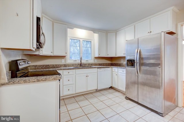 kitchen with white cabinets, sink, light stone countertops, and stainless steel appliances