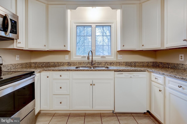 kitchen with white cabinets, stainless steel appliances, and sink