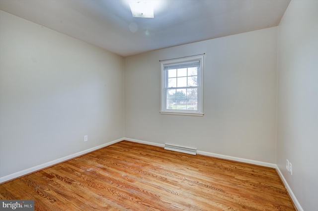 unfurnished room with light wood-type flooring