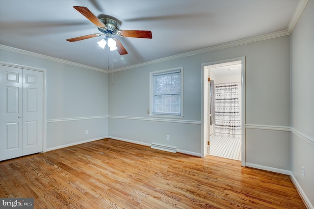 unfurnished bedroom featuring ceiling fan, light wood-type flooring, crown molding, and ensuite bath