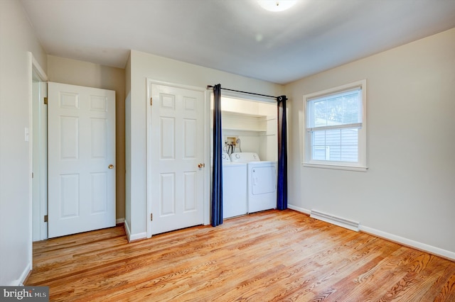 unfurnished bedroom with light hardwood / wood-style floors and washer and clothes dryer