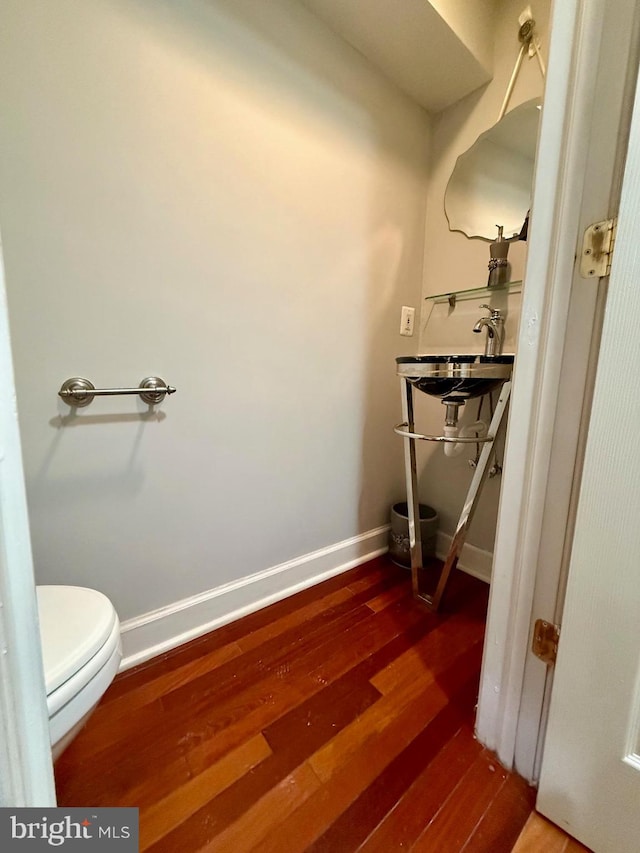 bathroom featuring hardwood / wood-style floors, toilet, and sink