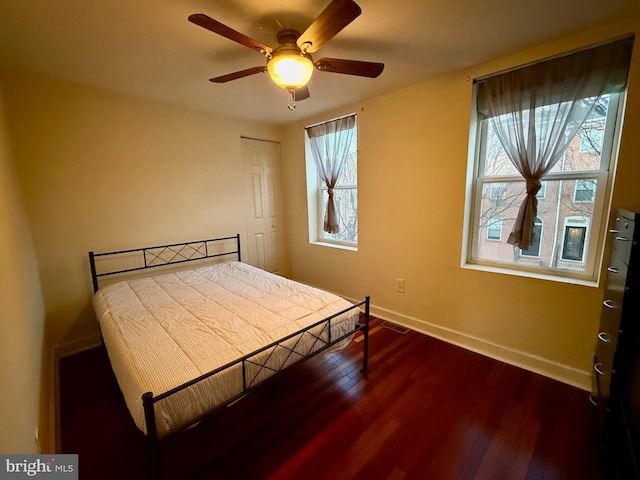 bedroom with hardwood / wood-style floors, a closet, and ceiling fan