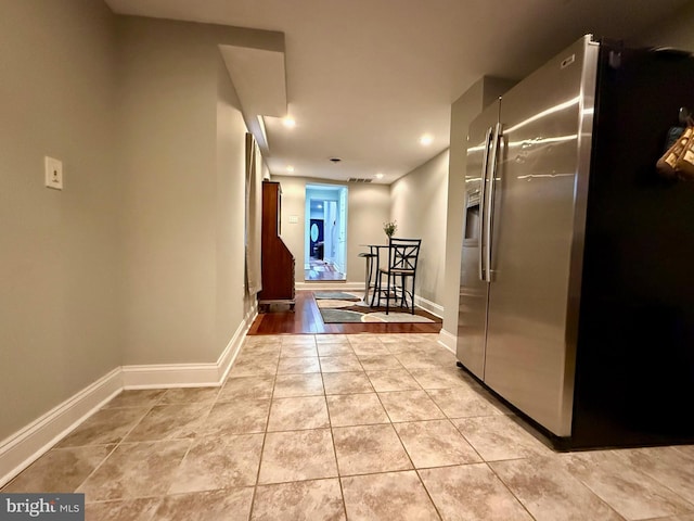 hallway with light tile patterned floors