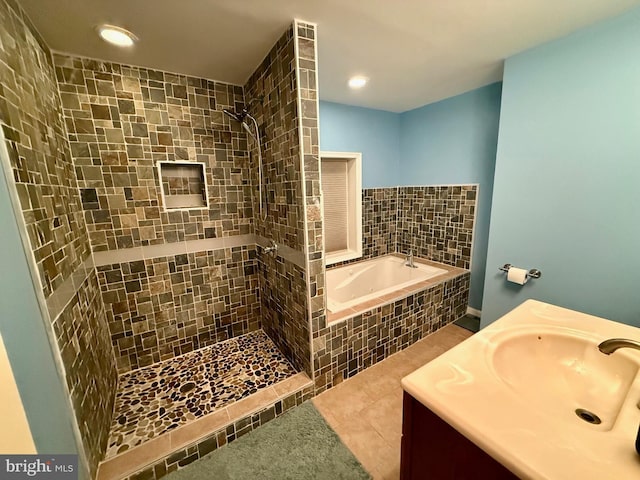 bathroom with tile patterned flooring, vanity, and independent shower and bath