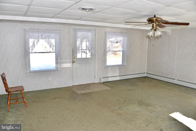 foyer entrance featuring carpet flooring, a paneled ceiling, ceiling fan, and a baseboard heating unit