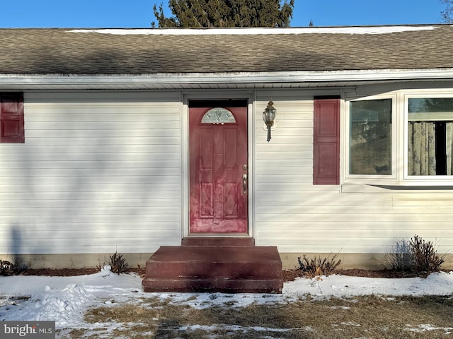 view of snow covered property entrance