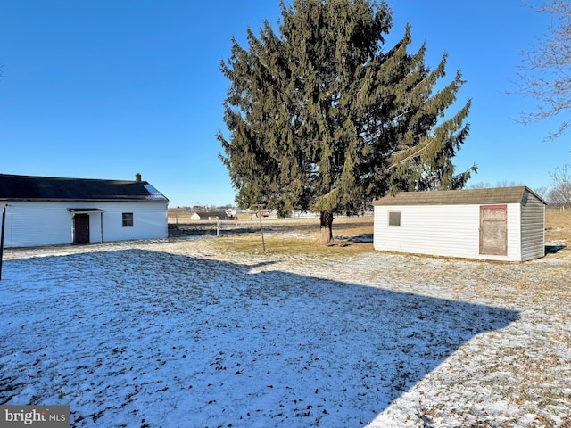 yard covered in snow with an outdoor structure