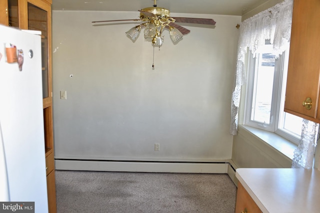 carpeted empty room with ceiling fan and a baseboard radiator