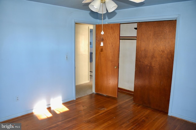 unfurnished bedroom featuring dark hardwood / wood-style floors, a closet, and ceiling fan