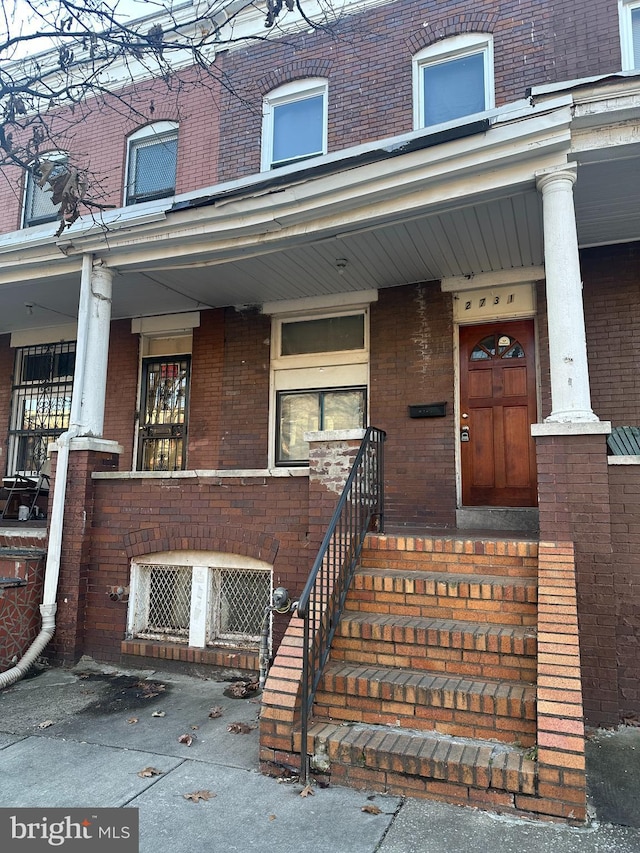 view of exterior entry featuring a porch