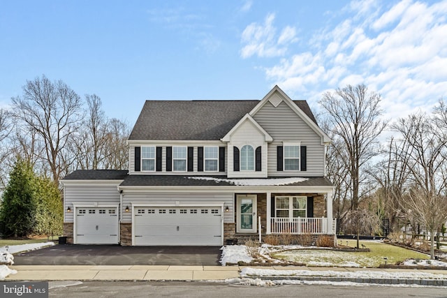 front of property featuring a porch and a garage