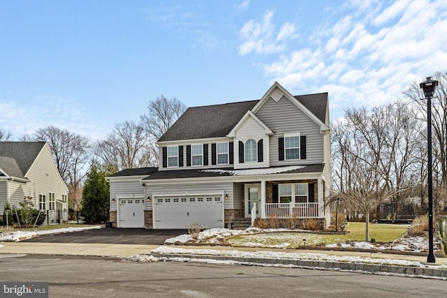 view of front of home featuring covered porch and a garage