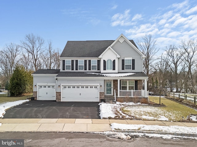 view of front of property featuring covered porch and a garage