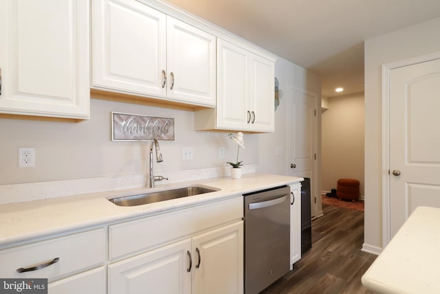 kitchen featuring white cabinetry, sink, stainless steel dishwasher, and dark hardwood / wood-style floors