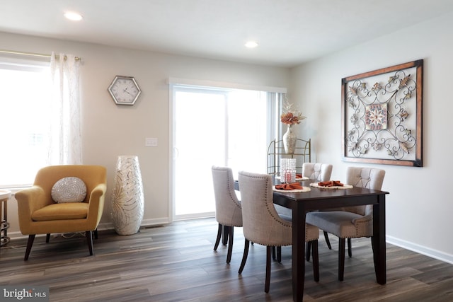 dining room with plenty of natural light and dark hardwood / wood-style floors