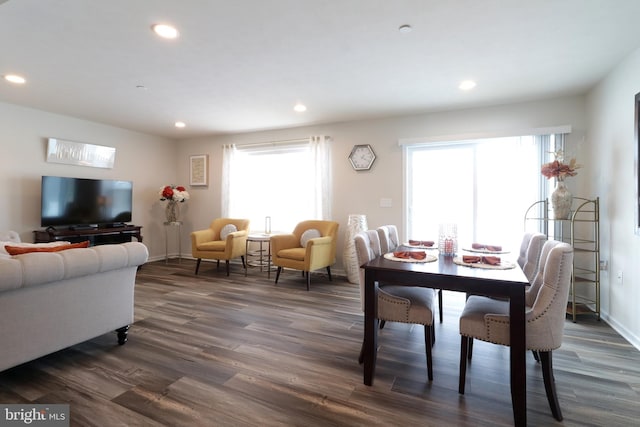 dining space featuring a healthy amount of sunlight and dark wood-type flooring