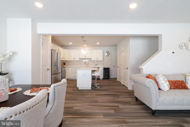 living room with dark hardwood / wood-style flooring