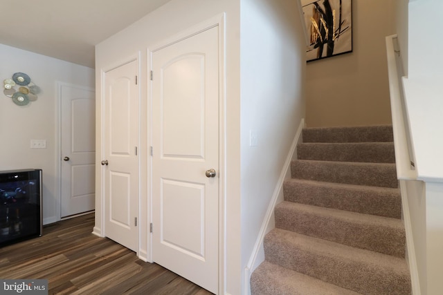 stairs featuring wine cooler and hardwood / wood-style flooring