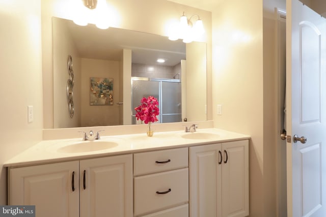 bathroom featuring vanity and an enclosed shower