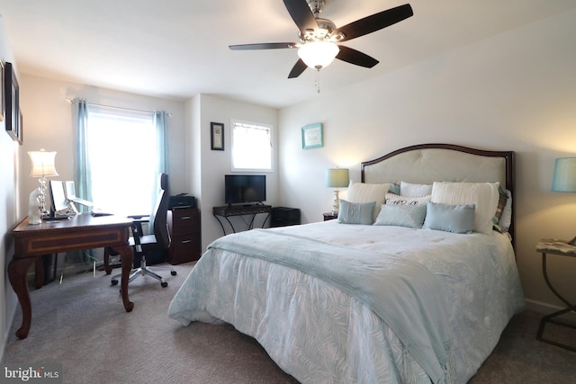 bedroom featuring multiple windows, ceiling fan, and carpet