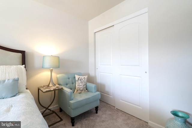 bedroom with light carpet and a closet