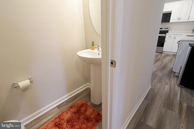 bathroom with hardwood / wood-style floors and sink