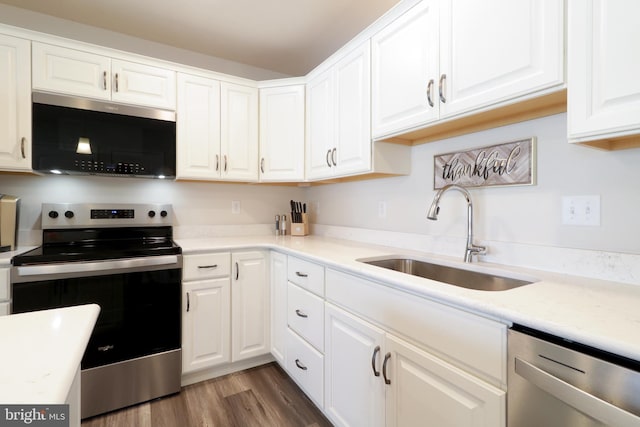 kitchen featuring sink, white cabinets, stainless steel appliances, and dark hardwood / wood-style floors