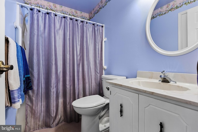 bathroom with vanity, tile patterned flooring, toilet, and walk in shower