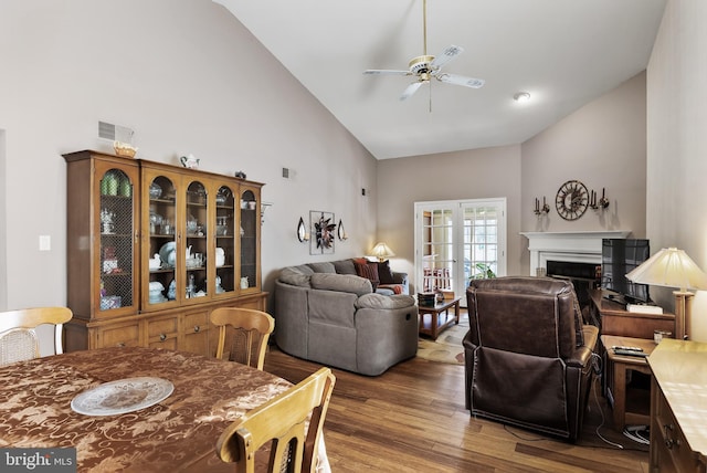 dining area featuring hardwood / wood-style flooring, ceiling fan, and high vaulted ceiling