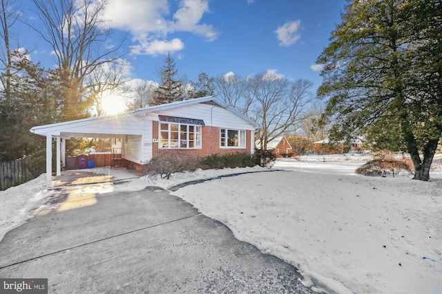 view of snow covered exterior featuring a carport