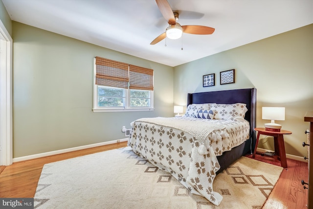 bedroom with ceiling fan and hardwood / wood-style flooring