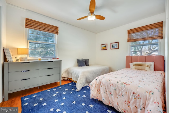 bedroom featuring ceiling fan and dark hardwood / wood-style flooring