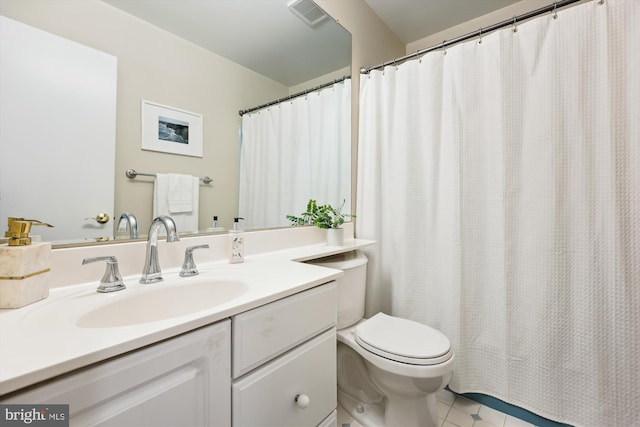 bathroom featuring tile patterned floors, vanity, and toilet