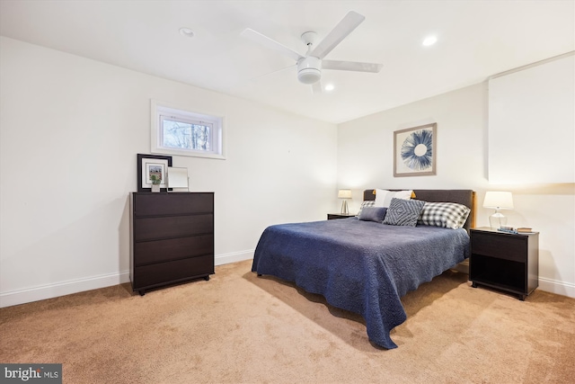 bedroom featuring ceiling fan and light carpet