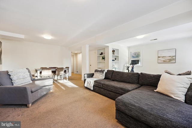 carpeted living room featuring built in features