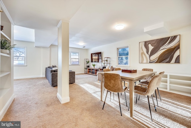 dining area featuring light carpet