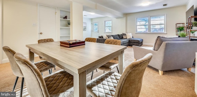 dining room featuring light carpet